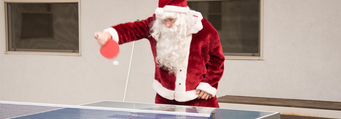 Photo of Santa playing ping pong at Orenco headquarters