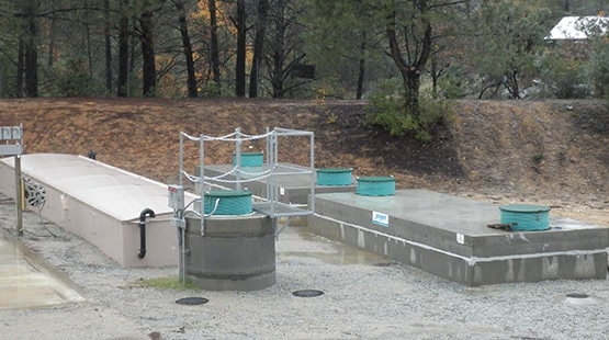 Photo of a commercial AdvanTex Treatment System installation and concrete tanks. Orenco’s AdvanTex® AX-Max™ Treatment Systems are a dependable, proven technology for primary-treated effluent to better-than-secondary standards, including nitrogen-reduction.