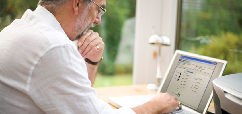 Photo of man on a laptop computer