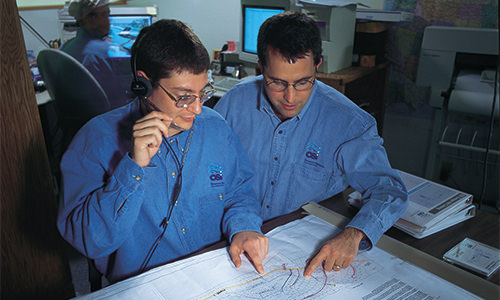 Photo of Orenco engineers conferring over site plans