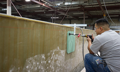 Photo of manufacturing staff working on a fiberglass structure